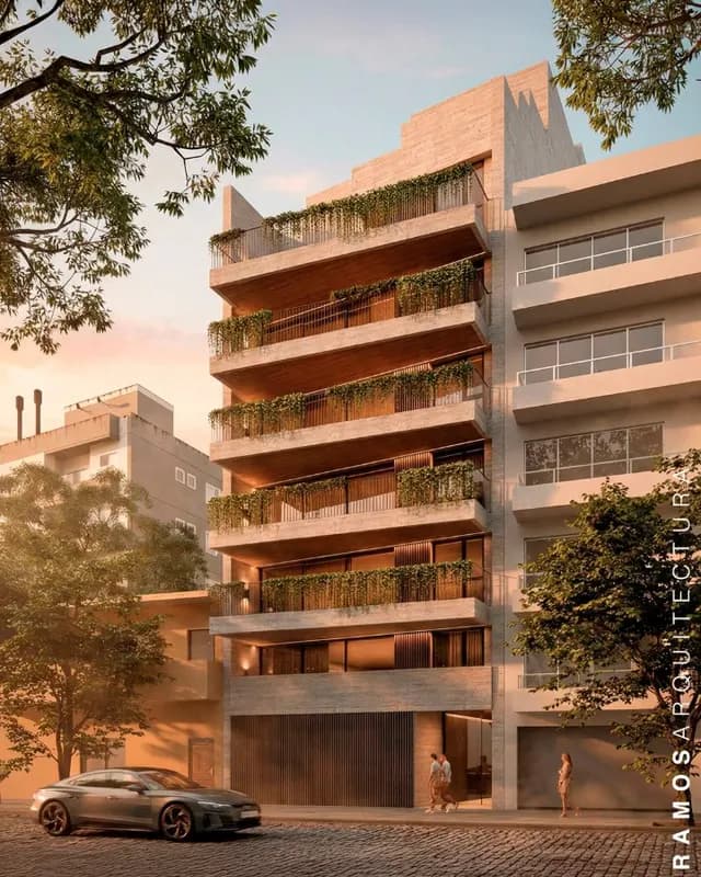 Edificio de departamentos con balcones verdes al atardecer - Ramos Arquitectura