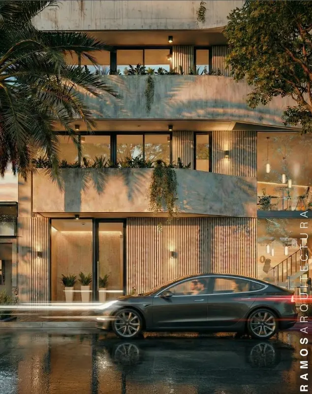 Edificio moderno de hormigón y madera con iluminación nocturna - Ramos Arquitectura